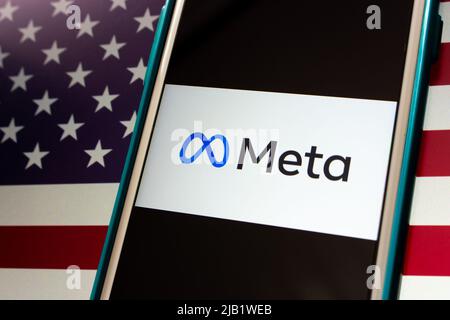 Kumamoto, JAPAN - Oct 29 2021 : Closeup logo of US technology conglomerate Meta Platforms, Inc. (formerly known as Facebook) on iPhone on US flag. Stock Photo