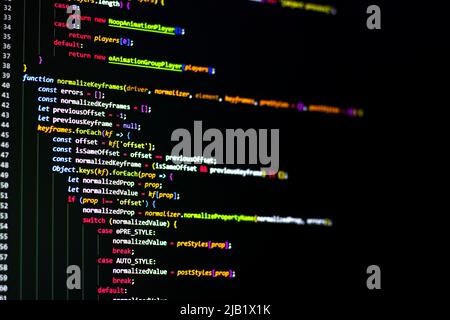 The software developer using dual screen is coding. Stock Photo