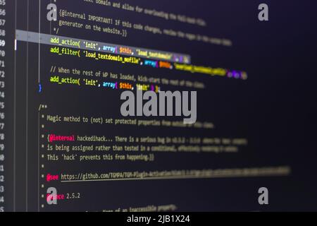 The software developer using dual screen is coding. Stock Photo