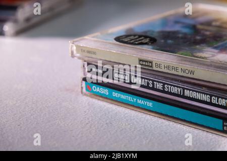 First 3 albums (Definitely Maybe, (What's the Story) Morning Glory? and Be Here Now) released in 1990’s by UK brit-pop rock band Oasis on the table. Stock Photo