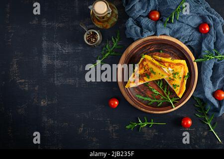 Roasted toast in scrambled eggs with ham, herbs and cheese cheddar. Delicious grilled breakfast sandwich Stock Photo
