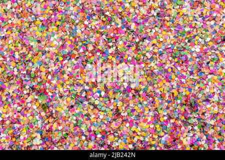 Two Gummy Bears are hidden and making out in a bed of confetti Stock Photo