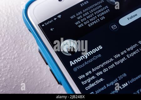 Kumamoto, JAPAN - Mar 23 2022 : Twitter account of Anonymous, a decentralized international activist and hacktivist collective, on an iPhone screen. Stock Photo