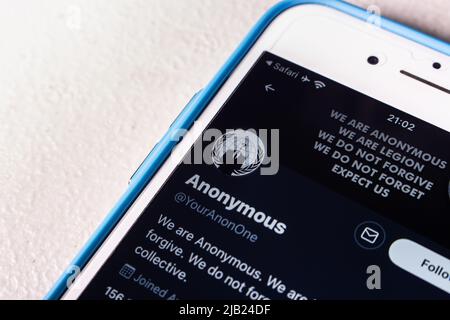 Kumamoto, JAPAN - Mar 23 2022 : Twitter account of Anonymous, a decentralized international activist and hacktivist collective, on an iPhone screen. Stock Photo