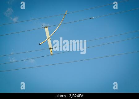 Wood pieces placed between the electric current lines to prevent bypass Stock Photo