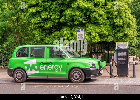 Ovo Energy branded E-taxi recharging at a dedicated rapid electric charging point in central London.