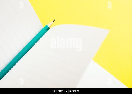 Simple education and business concept still life. A pencil on an open notebook. Stock Photo