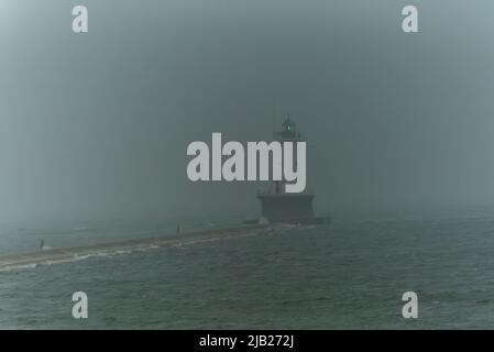 Ludington North breakwater light in the fog guiding ships to safety Stock Photo