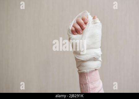 Children's hand in a medical plaster close-up Stock Photo