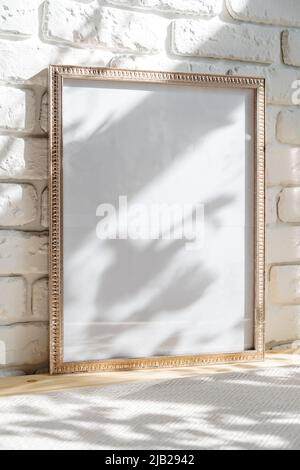 Photo frames on floor over white brick wall Stock Photo