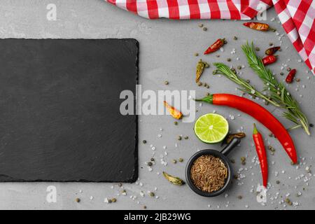 Various spices and herbs on gray background Stock Photo