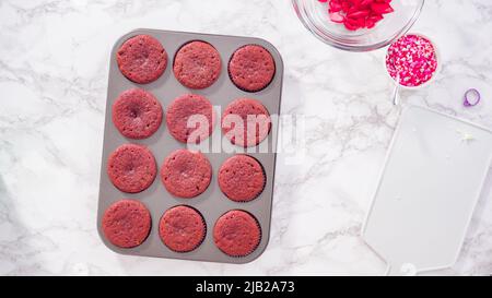 Flat lay. Step by step. Cooling red velvet cupcakes on a kitchen drying rack. Stock Photo