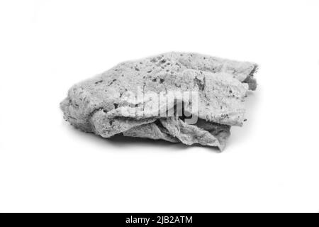 Old dirty torn rag isolated on white background. Cleaning rag. Stock Photo