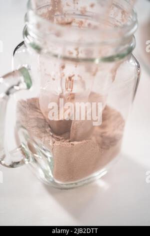 Making unicorn hot chocolate mix in drinking mason jar as a food gift. Stock Photo