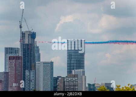 London, UK 2nd June 2022. The RAF Red Arrows seen passing behind new tower blocks at Battersea. The Red Arrows were the finale of a fly past commemorating the Platinum Jubilee of Her Majesty Queen Elizabeth II. Credit: Tom Leighton/Alamy Live News Stock Photo