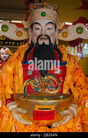 Traditional Chinese elder or deity figure displayed outside a store near the Kwan Im Thong Hood Cho Temple in Waterloo Street, Singapore Stock Photo