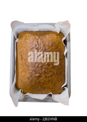 Freshly baked fruit cake in the baking tray on a white background. Homemade cake. Stock Photo