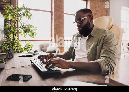 Portrait of focused serious web designer keyboard typing implement server protection workstation indoors Stock Photo