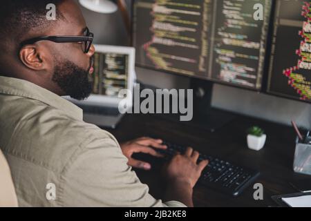 Profile side view portrait of attractive focused experienced smart skilled guy expert editing data at workplace workstation indoors Stock Photo
