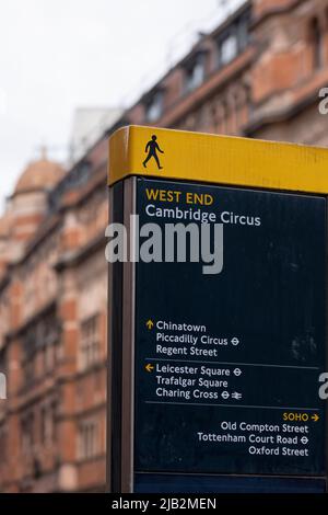 LONDON, UK - MAY 26, 2022:  Tourist information sign in Cambridge Circus Avenue with defocussed Palace Theatre background Stock Photo