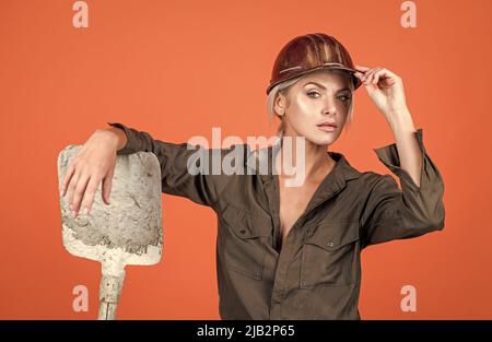 a bit tired. building and construction. lady architect worker. engineer on orange background Stock Photo