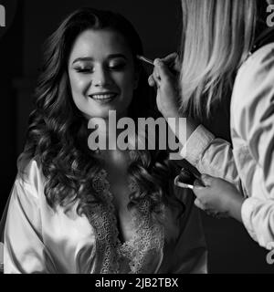 Dolyna, Ukraine June 26, 2021: the morning of the bride, pleasant petitions in the house, the bride and her details, applying makeup. Stock Photo