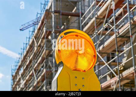 Shell of an apartment building with scaffolding and warning light in the foreground in Bad Homburg (Vickers - Areal) near Frankfurt on the Main Stock Photo
