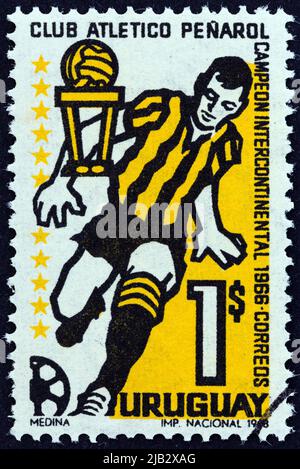 URUGUAY - CIRCA 1968: A stamp printed in Uruguay issued for Penarol Club's Victory in Intercontinental Football Championships shows footballer. Stock Photo