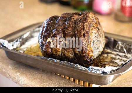 A large prime rib beef roast that was baked and roasted in the oven by a home gourmet chef for a holiday Christmas dinner Stock Photo