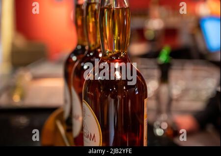 Different ages and colours of strong alcoholic apple drink calvados in Normandy, Calvados region, France, calvados tasting tour Stock Photo