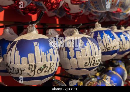 Christmas balls on red shelf are sold on a store at Lower Manhattan, New York City, USA. The details on the balls are new york skyline. Stock Photo