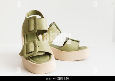 Leather women's platform sandals in olive color, top view isolate. female foot fashion Stock Photo