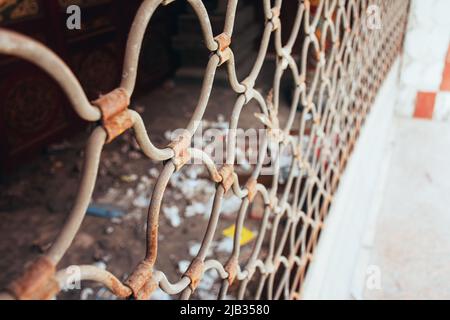 Closed rusty metal door of a long abandoned small business. Selective focus. Concepts of crisis, abandonment or bankruptcy Stock Photo