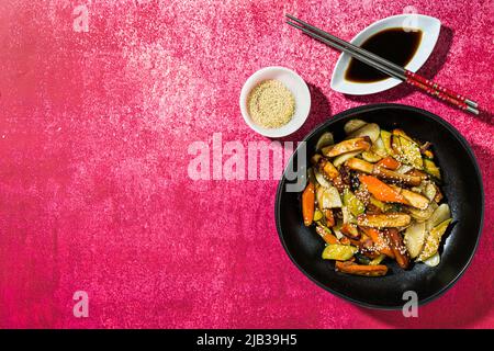 rice cake with vegetables in the plate. served with soy sauce Stock Photo