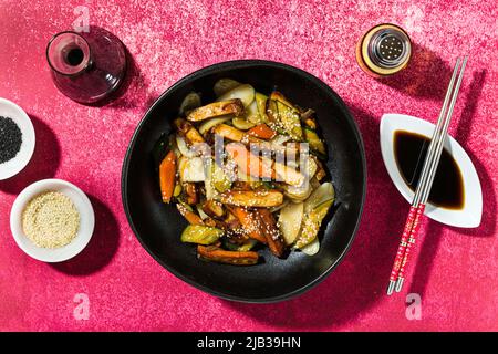 rice cake with vegetables in the plate. served with soy sauce Stock Photo