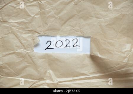 2022 written on paper on a torn piece of paper, happy new year 2022