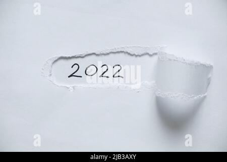 2022 written on paper on a torn piece of paper, happy new year 2022