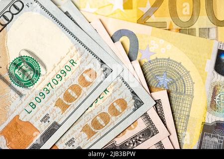 One hundred dollar bills on 200 euro banknotes. Euro and dollar exchange concept, trade between USA and European Union. Stock Photo