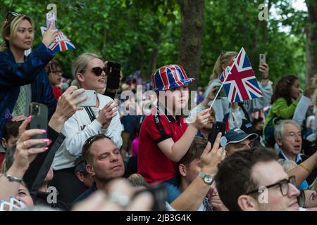 London, UK. 02nd June, 2022. Spectators gathered along The Mall wave flags during the Trooping the Colour military parade to honour the official birthday Her Majesty the Queen and the Platinum Jubilee. Millions of people in the UK are set to join the four-day celebrations marking the 70th year on the throne of Britain's longest-reigning monarch, Queen Elizabeth II, with over a billion viewers expected to watch the festivities around the world. Credit: Wiktor Szymanowicz/Alamy Live News Stock Photo