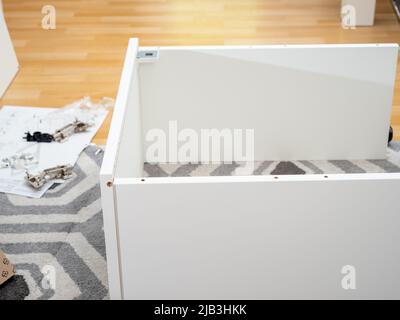 A worker assembles new furniture. High quality photo Stock Photo