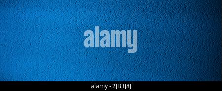 Blue painted wall background or texture. Panoramic dark blue backdrop surface for banner Stock Photo