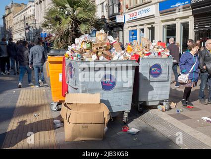 Rubbish Bins overflowing with trash on rugby international match day in St Mary Street in Cardiff South Wales Stock Photo