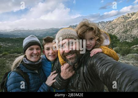 Family making a selfie in the mountain Stock Photo