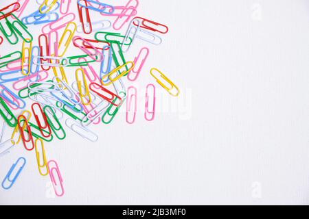 Colored paper clips on a white background Stock Photo