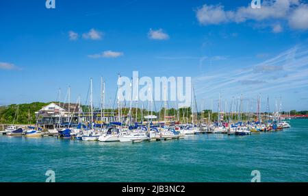 Docked or moored yachts, sailing boats and other boats on pontoons at the Arun Yacht Club on the River Arun in Littlehampton, West Sussex, England, UK Stock Photo