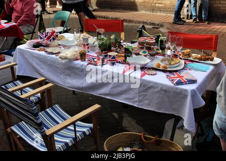 A typical table at a street party in Sidmouth, Devon celebrating Queen Elizabeth's Platinum Jubilee on June 2, 2022. Jubilee table after feasting. Stock Photo