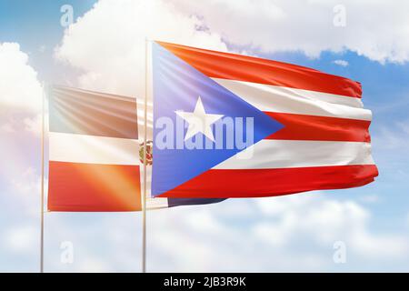 Sunny blue sky and flags of puerto rico and dominican republic Stock Photo