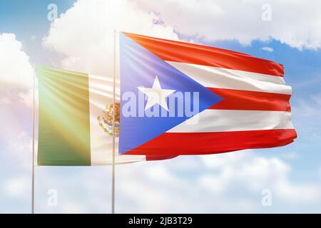 Sunny blue sky and flags of puerto rico and mexico Stock Photo