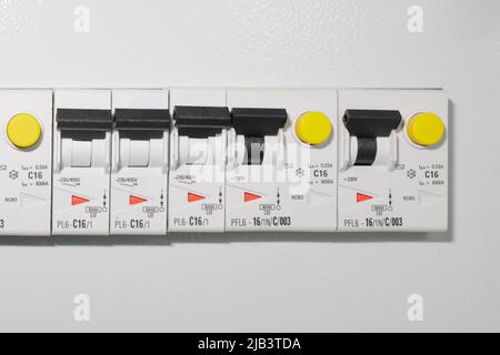 Light switches on a gray wall background in a house or hotel. Copy space. Stock Photo