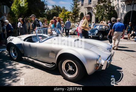 Spectators enjoy classic cars in downtown Carmel, seen at the Carmel-by-the-Sea Concours on the Avenue event during Monterey Car Week Stock Photo